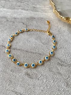 🧿 Stunning handmade White Evil eye jewellery, available, crafted from tarnish resistant stainless steel 🧿. This bracelet will fit any wrist size as its adjustable. The evil eye is a protective and powerful symbol, also known as the Nazar. The evil eye helps to absorb negative energies, protect and bring luck. The evil eye makes a perfect gift for yourself and loved ones.  Hand of Fatima Necklace https://www.etsy.com/uk/listing/1556603231/hamsa-hand-of-fatima-gold-pendant?click_key=a6f5da90d8d8ea8bd774c20becf761f1cd89bc53%3A1556603231&click_sum=a9a084e9&ref=shop_home_active_3 Hand of Fatima Earrings https://www.etsy.com/uk/listing/1542499652/hamsa-hand-of-fatima-gold-stud-earrings?click_key=89cabcb8ef68040716616f6d3e33732975d65ab1%3A1542499652&click_sum=5e820e7d&ref=shop_home_active_1 💎J Hand Of Fatima, Eye Make, Evil Eye Bracelet, Hamsa Hand, Evil Eye Jewelry, Gold Studs, Gold Earrings Studs, Evil Eye, Chain Link Bracelet