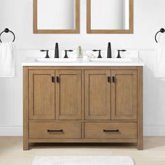 a bathroom vanity with two mirrors above it