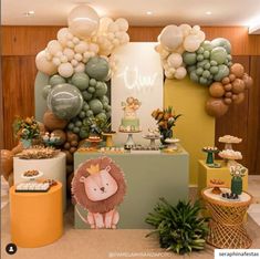 an animal themed birthday party with balloons and desserts