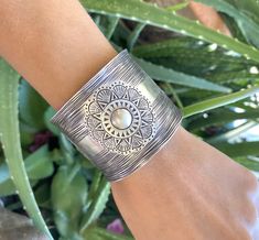 "❋ Handmade Sterling Silver Wide Boho Statement Cuff with Engraved Oxidized Silver Solar Mandala ❋ Dimensions: Width: About 1.5\" (3.8 cm), Length: About 6.9\" / 17.5cm ❋ Metal Purity: 95% Pure Silver (Purer than 925 Sterling Silver) To browse some more of our Silver Jewelry collection you can click on the following links: https://www.etsy.com/shop/SilverShapes Earrings: https://www.etsy.com/shop/SilverShapes?section_id=14809462&ref=shopsection_leftnav_1 Rings: https://www.etsy.com/shop/Silv Artisan Adjustable Bangle For Festivals, Artisan Adjustable Cuff Bracelet With Intricate Design, Artisan Bangle Cuff Bracelet For Festivals, Artisan Cuff Bracelet With Intricate Adjustable Design, Bohemian Cuff Bracelet For Weddings, Bohemian Wide Band Engraved Jewelry, Bohemian Wedding Cuff Bracelet, Bohemian Cuff Bracelet For Festivals With Intricate Design, Bohemian Cuff Bracelet With Intricate Design For Festivals