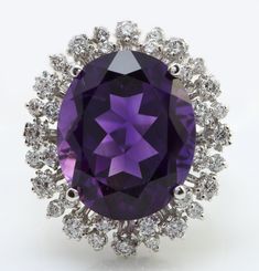 11.20 Carat Natural Purple Amethyst and Diamond Women Ring Made in 14K Solid White Gold Suggested Retail Value $5,999.00 Total Natural Amethyst Weight is - 10.00 carat Amethyst Measurements are - 16.00 x 12.00 Gold Purity: 14K Round Diamonds Carat Weight is - 1.20 Carat Clarity: SI1 Color: G-H RING SIZE: 6 (FREE SIZING AVAILABLE) RING WEIGHT IS 7.9g Disclaimer: All weights, measurements and colors are approximate and may vary slightly from the listed dimensions or as seen in the image'' Thanks for looking and good luck! Luxury Purple Gemstones With Halo Setting, Luxury Purple Amethyst Ring With Halo Setting, Luxury Purple Platinum Rings, Luxury Brilliant Cut Amethyst Ring In White Gold, Luxury White Gold Amethyst Ring With Brilliant Cut, Formal Purple Cubic Zirconia Diamond Ring, Luxury Purple Diamond Ring For Formal Occasions, Luxury White Gold Amethyst Ring With Halo Setting, Luxury Amethyst Ring With Halo Setting