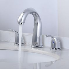 two faucets running water in a bathroom sink