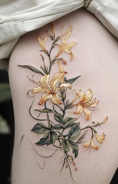 a woman's thigh with flowers painted on it