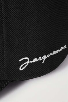 JACQUEMUS La Casquette embroidered cotton-twill baseball cap | NET-A-PORTER Black Hats With Logo Detail For Streetwear, Black Hat With Logo Detail For Streetwear, Black Hat With Logo For Streetwear, Cotton Snapback Baseball Cap With Logo, Black Baseball Cap With Logo, Curved Visor, Black Baseball Cap With Logo Detail, Classic Black Snapback Hat With Embroidered Logo, Casual Black Baseball Cap With Logo Detail, Cotton Baseball Cap With Logo Detail