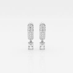 Indulge in a magical sparkle with the Bombë Micro Radiant Dangle Huggie Earrings. Small but impactful, these 14K gold huggie earrings are adorned with scintillating lab grown pave diamonds and made even more luxurious with a drop radiant diamond. This eye-catching design will elevate any outfit. Luxury Timeless Diamond Huggie Earrings, Luxury White Gold Pierced Huggie Earrings, Luxury Formal Pierced Huggie Earrings, Luxury Sparkling Huggie Hoop Earrings, Luxury White Elegant Huggie Earrings, Luxury White Gold Huggie Dangle Earrings, Luxury Classic Lab Grown Diamond Earrings, Luxury Engagement Huggie Earrings, Luxury Huggie Earrings With Prong Setting