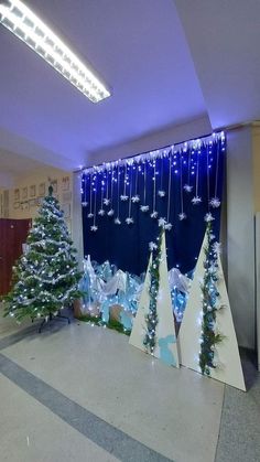 an office decorated for christmas with trees and snowflakes hanging from the ceiling,