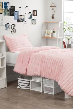 a bedroom with white walls and pink bedding