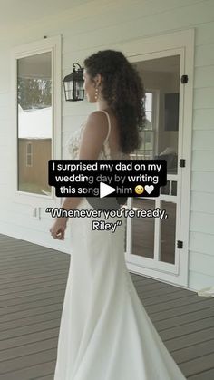 a woman in a wedding dress standing on a porch with her back to the camera