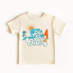 The Big One Shirt, Custom 1st Birthday Shirt, Surf Birthday tee, Surfs Up, Surfer Ocean Wave tee **HOW TO ORDER** 1. Select the color and size/name from the drop-down menu and add it to the cart 2. Repeat the process if you want to order more shirts **SIZE CHART** Please scroll through the listing photos to see the size charts. **DESIGN SPECIFICS** We print our shirts using Direct To Garment printing technology. process which makes the design naturally blend into the fabric, making it very soft to touch.  **SHIRTS** white and natural are 100% cotton **PROCESSING TIME** Made to Order Please allow 1-5 business days for your order to be completed.PLUS SHIPPING TIME . **SHIPPING TIME** Depends on the shipping method chosen and destination, but in general after the order is placed, the package First Birthday Graphic Tee With Crew Neck, Cotton Graphic Print T-shirt For Birthday, First Birthday Graphic Tee With Name Print, Graphic Tee With Name Print For First Birthday, White Cotton T-shirt For First Birthday, First Birthday Graphic Tee With Short Sleeves, Short Sleeve Shirt For First Birthday In Summer, First Birthday Crew Neck Shirt With Graphic Print, First Birthday Graphic Print Crew Neck Shirt