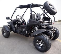 an off - road vehicle parked in a parking lot with two tires on the side