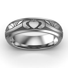 TITANIUM Claddagh Wedding Ring ASI-UCL2-TITAN6M Titanium Claddagh Wedding Ring Available in sizes from 6 through 13Available also in 10K Gold, 18K Gold, Platinum, White Gold, Yellow Gold, or Rose Gold. Our Titanium Claddagh Wedding Ring displays one Claddagh icon - hands, heart, and crown, 6 interwoven trinity knots, and 1 Celtic Rose knot. The length of the branch is tailored to the size of the ring, giving a smaller appearance to the corresponding smaller size. Our Titanium Claddagh rings offe Claddagh Wedding Ring, Celtic Rose, Claddagh Symbol, Claddagh Ring Wedding, Titanium Wedding Rings, Trinity Knot, Claddagh Rings, Ring Displays, Titanium Rings