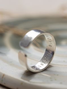 .925 Sterling silver adjustable ring.  A chunkier version of our rings for men (or women of course) with hammered effect  6mm x 1.5 mm Each letter is individually hand stamped by myself, with your own names, dates or choice of words. (up to 20 characters per line) A heart or star can be added by simply adding an emoji or (Heart) (Star) where you would like it placed.  For example  (Star) we love you daddy  Elsie and Charlie  Adjustable size, so one size fits all.  To adjust gently pull or push to create the desired size.  Presented in an eco friendly  'Raspberry Ripple' gift box. Band Boyfriend, Raspberry Ripple, Hammered Band, Secret Messages, Lovely Ring, Open Ring, Adjustable Ring, Stackable Rings, Engagement Gifts