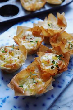 small appetizers are sitting on a blue and white plate