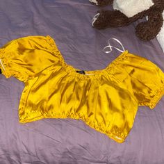 Silky Yellow Crop Top Yellow Summer Crop Top For Party, Yellow Crop Top For Summer Party, Yellow Summer Party Crop Top, Chic Yellow Short Sleeve Crop Top, Yellow Crop Top For Day Out, Gold Crop Top For Summer, Trendy Yellow Tops For Night Out, Trendy Gold Summer Tops, Trendy Gold Tops For Summer