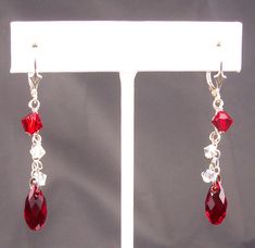 "Stunning ruby red Swarovski Elements briolette teardrops sway from petite sterling silver chains. The red crystal is accented by Swarovski Elements aurora borealis crystals. These cascade earrings have decorative sterling silver lever back ear wires and are 2 inches (51 mm) long. Sterling silver ear hooks are also available. Free USPS first class domestic shipping on all KBeadsIt jewelry. Matching necklace (last picture): https://www.etsy.com/listing/558422442 See my entire collection at https: Red Drop Jewelry With Matching Earrings, Red Drop Crystal Earrings As Gift, Red Drop Beads For Jewelry Making, Red Teardrop Earrings With Dangling Beads, Red Dangle Crystal Earrings For Anniversary, Red Sterling Silver Drop Crystal Earrings, Red Sterling Silver Crystal Drop Earrings, Red Sterling Silver Dangle Crystal Earrings, Red Teardrop Earrings For Anniversary