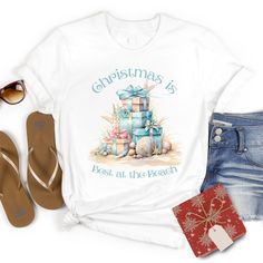 Christmas is Best at the Beach. The pastel gifts and seashells are perfect for anyone who loves a coastal, beachy Christmas.This basic tee is perfect for anyone who loves Christmas at the beach or near the ocean. The Gildan 64000 softstyle Unisex Sized T-shirt is very soft, durable and comfortable. Solid colors are 100% ring-spun cotton Sport Grey is 90% ring-spun cotton, 10% polyester Fabric weight: 4.5 oz/yd² (153 g/m²) Regular Unisex Fit, Size up if you prefer a loose or oversized fit. Averag Christmas At The Beach, Beachy Christmas, Beach Christmas, Beach Watercolor, Coastal Christmas, Christmas Vacation, Cute Hats, Basic Tee, Christmas Mugs