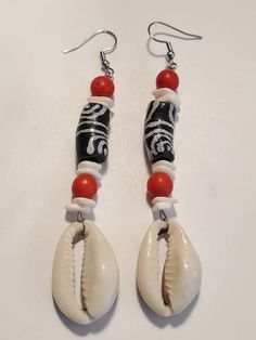 Black White Ghana Krobo Cowrie Shell Dangle Earrings https://etsy.me/35k1qNV White Drop Earrings With Black Beads, White Dangle Jewelry With Black Beads, Black Beach Jewelry With Dangling Beads, Beach Jewelry With Black Dangling Beads, Black Dangling Beads Jewelry For Beach, Bohemian White Earrings With Black Beads, Gift White Beaded Earrings With Black Beads, Black Dangle Jewelry For Beach, Unique White Jewelry With Black Beads