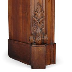 an old wooden cabinet with carvings on the front and sides, inlaid with leaves