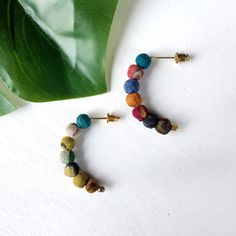 These Kantha Petite Arc Earrings are bold yet understated. Seven colorful Kantha textile beads come together to form a slight arc. Each piece is made from recycled Kantha textiles, so colors and patterns are all one-of-a-kind and will vary. Measures 1" long and finished with nickel and lead-free ear wires. Sustainably handmade by women artisans in India. Orb Necklace, Women Art, Free Earrings, Women Artisans, Ear Wires, Statement Necklace, Textiles, Beads, Pattern