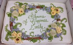 a cake in a box decorated with flowers and the words flowers of happiness, family