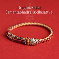 Introducing our exquisite Handmade 925 Sterling Silver Year of the Dragon Chinese Zodiac Natal Buddha Protection Rope Bracelet, a piece of jewelry that beautifully intertwines ancient symbolism with modern craftsmanship. Crafted with utmost precision and care, this bracelet is made from premium quality 925 sterling silver, ensuring durability and timeless elegance. The centerpiece of this bracelet features the majestic dragon, symbolizing power, strength, and good fortune in Chinese culture. Each intricate detail of the dragon is meticulously carved to capture its essence and mystique. In addition to the dragon, the bracelet also incorporates the Natal Buddha, a symbol of protection, guidance, and enlightenment. This combination of auspicious symbols makes it not only a stunning accessory Traditional Snake Shape Jewelry Gift, Traditional Red Bracelets For Meditation, Traditional Adjustable Engraved Braided Bracelets, Traditional Engraved Adjustable Braided Bracelets, Traditional Adjustable Engraved Braided Bracelet, Adjustable Spiritual Bracelets For Ceremonial Use, Red Spiritual Bracelets For Rituals, Spiritual Red Bracelets For Rituals, Adjustable Red Engraved Jewelry