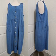 Beautiful denim dress, I'm so excited for whoever gets this dress, it's just the prettiest denim market dress! It buttons up the front and has a cute button detail on the shoulders, pockets on front, and a slight empire waist. The brand is Blair and it is size large. It comes with an extra button as well. Please read over the dress measurements carefully, to make sure the fit is okay for you, as I'm unable to accept returns/exchanges at the moment. Measurements are taken while garment is laid fl Cotton Denim Midi Dress With Buttons, Cotton Denim Midi Dress With Button Closure, Cotton Midi Denim Dress With Button Closure, Elegant Ribbed Collar Top, Medium Wash Buttoned Midi Dress, Medium Wash Midi-length Dress With Buttons, Medium Wash Midi Length Dress With Buttons, Dark Wash Midi Dress With Pockets, Blue Cotton Midi Dress With Pockets