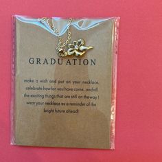 a card with a gold graduation necklace on it