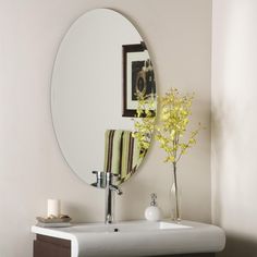 a bathroom with a sink, mirror and towel on the counter in front of it