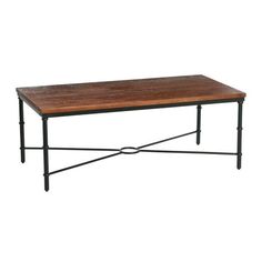 a wooden table sitting on top of a metal frame base with an iron framework around it