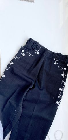 a 1970s black cowboy pants with white stoctching and white nap button closures at hips. zips up nicely. elastic back waist 19 rise 9 inseam 27 hips 30 Western High Waist Fitted Bottoms, Western Style Fitted High Waist Bottoms, Western Straight Leg Cotton Bottoms, Western Style Straight Leg Cotton Bottoms, Cotton Straight Leg Western Bottoms, Western Style Cotton Straight Leg Bottoms, 70s Cowboy, Western Pants, Cowboy Pants