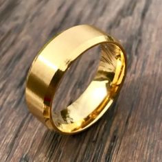 a gold ring sitting on top of a wooden table