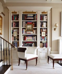 a living room filled with lots of books and furniture