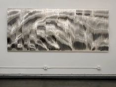 an abstract painting is displayed on the wall