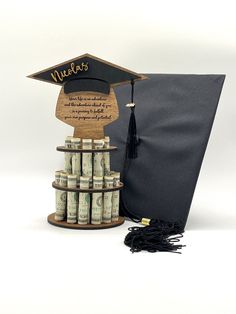 a graduation cap on top of stacks of money