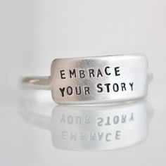 "The Cherished inspiRING makes for the perfect everyday ring that features your favorite little reminder. Designed to be the little sister to the wide inspiRING, this ring will be one you cherish for years to come. Letters are individually stamped by hand, making each ring one of a kind. The message is left justified in our signature teeny-tiny upper case block font. Choose one of our messages https://www.etsy.com/listing/896792268 or create your own. details + message plate measures 5/8\" wide Everyday Meaningful Hand Stamped Stackable Rings, Everyday Minimalist Hand Stamped Rings, Minimalist Everyday Hand Stamped Rings, Inspirational Adjustable Sterling Silver Rings, Adjustable Inspirational Sterling Silver Rings, Adjustable Inspirational Rings For Everyday, Minimalist Hand Stamped Rings For Everyday, Meaningful Everyday Sterling Silver Stackable Rings, Personalized Everyday Stackable Rings