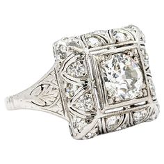 an antique style diamond ring with filigrees