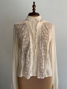 "Vintage blouse from the 1930s. Entirely hand stitched, very delicate and quality is immaculate. Chantilly lace, silk crepe, mother of pearl buttons. Pit to pit: 19\" Neck across: 6\" Length: 21\" Sleeve length from shoulder: 24\"" Vintage Silk Blouse, Vintage Silk Blouse For Formal Occasion, Elegant Silk Blouse With Lace Trim, Silk Tops With Lace Trim For Daywear, Vintage Lace Top With Ruffles, Classic Lace Tops With Lace Work, Elegant Cream Lace Top With Patchwork, Cream Lace Blouse With Lace Cuffs, Elegant Cream Lace Top With Lace Collar