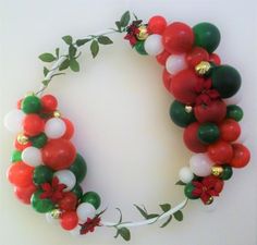 a wreath made out of red, white and green balloons