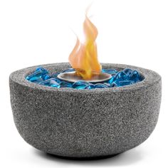 an outdoor fire pit with blue rocks and flames in the center on a white background