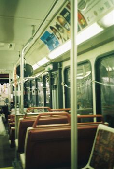 the inside of a subway car with lots of seats