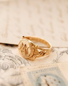 The Marie Antoinette Ring her monogrammed rIng MA, she was the queen of France brfore the French Revolution.  This beautiful ring made of 18k gold plated silver and inscribed inside Eat Cake. All items come in a gift box ready to gift. To see more please visit my Etsy shop at https://www.etsy.com/shop/BijouLimon Bijou Limon jewelry collections present a romantic French spin on the latest jewelry trends. Based on the US West Coast but French at heart, Bijou Limon interprets the current jewelry tr Marie Antoinette Jewelry, Vintage French Wedding, Rococo Jewelry, Wax Seal Ring, Queen Of France, Jewelry Wax, The French Revolution, Latest Jewellery Trends, Seashell Earrings