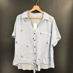 Size: Xxl Color: Blue And White Stripe Floral Embroidery Specifics: Candie's Button Up Shirt Tie Front Scout Shirt Button Front With Tie Faux Front Pocket 100% Rayon Condition: Good Used Condition, No Rips Or Stains Noted Measurements Are Approximate And Taken Laying Flat Armpit To Armpit: 25.5" Shoulder To Hem: 24" Shoulder To Cuff: 5" See Photos For Details Nk18 Casual Collared Blouse With Floral Embroidery, Light Blue Vacation Top With Button Closure, Light Blue Tops With Button Closure For Vacation, Casual Button-up Blouse With Floral Embroidery, Casual Embroidered Collared Tops, Casual Embroidered Collared Blouse, Relaxed Fit Floral Embroidery Shirt For Vacation, Beach Cotton Shirt With Floral Embroidery, Cotton Beach Shirt With Floral Embroidery