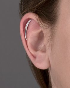 a close up of a person's ear with a single piece of metal in the middle