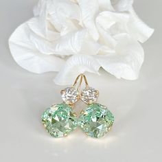 "Sparkly, eye-catching, chrysolite green and clear crystal earrings will brighten up any outfit! Swarovski's precision-cut crystals and unmatched, gorgeous colors are always show-stoppers! Details: * Square Swarovski Crystals- 1/2\"( 13mm), 3/8\"(10mm) * 14k Gold-plated lever back Earrings  * Earring Length- 1 1/4\"(30mm) * Lead and Nickel-free * Earrings come in a jewelry bag and box with ribbon. The link to the colorful orange earrings- https://www.etsy.com/listing/1721152117/yellow-orange-crystal-drop-earrings?click_key=a2122a70736e3345002545b74c491d62fa76ce38%3A1721152117&click_sum=4972b409&ref=shop_home_active_7&frs=1&sts=1" Clear Crystal Earrings, Orange Crystals, Orange Earrings, Nickel Free Earrings, Swarovski Crystal Earrings, Colorful Jewelry, Crystal Drop Earrings, Crystal Drop, Wedding Jewelry Earrings