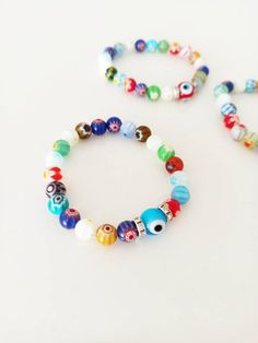 ⭐️The millefiori beads on the stretch bracelets are made of glass. ⭐️These Italian Floral beaded bracelets include multicolored Millefiori beads with glass evil eye. ⭐️This Millefiori Stretch Bracelet with Evil eye charm would be the perfect gift as a protection amulet. For more evil eye bracelets, click the link below; https://www.etsy.com/shop/EyeDesignsbyGG?ref=search_shop_redirect&section_id=30219689 Multicolor 8mm Beads Evil Eye Bracelet, Multicolor Evil Eye Bracelet With Colorful Round Beads, Adjustable Multicolor Evil Eye Bracelet With 8mm Beads, Multicolor Beaded Bracelets With Evil Eye, Spiritual Multicolor Beaded Bracelets With Evil Eye, Multicolor Beaded Evil Eye Bracelet Spiritual, Multicolor Beaded Evil Eye Bracelet, Bohemian Multicolor Round Beads Evil Eye Bracelet, Spiritual Multicolor Stretch Bracelet With Spacer Beads