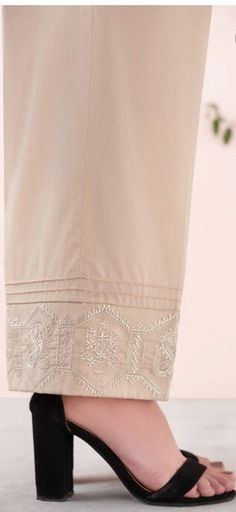 Look your best by wearing this embroidered trousers to pair with any dress. Detail: - Color: Gold - Fabric: Cambric - Loose Straight Trousers with Pintucks - Embroidered Hem Beige Cotton Pants With Floral Embroidery, Beige Floral Embroidery Pants For Summer, Fitted Embroidered Bottoms For Wedding, Summer Embroidered Beige Pants, Embroidered Straight Beige Pants, Beige Embroidered Straight Pants, Beige Floral Embroidered Pants, Fitted Bottoms With Chikankari Embroidery For Wedding, Summer Cotton Pants With Embroidered Hem