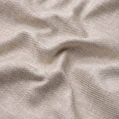 an up close shot of the texture of a beige fabric, which is very soft and wrinky