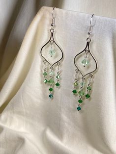 Stand out with these beautiful crystal earrings! Made with genuine Swarovski beads, they have a shine unlike any other bead. Wear to a formal event or with jeans and a T-shirt to jazz up any outfit. Long Beaded Earrings, Earrings Fancy, Earrings Prom, Beaded Chandelier Earrings, Green Gradient, Prom Earrings, Fancy Earrings, Swarovski Beads, Beaded Chandelier