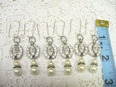 These earrings are breathtaking and sparkle like diamonds! These feature repurposed pieces of a vintage authentic signed BOGOFF art Deco rhinestone piece -- see last picture. NOTE -- NONE of these pieces are signed -- the last picture is of another one of the pieces I used in another set). These feature glass ivory faux pearl drops and are for pierced ears, and hang on silver tone kidney ear hooks. Please see all pictures on these for a better description and sizing. (Section P12)L 20’s Style, 1940s Art Deco, 1940s Art, Bridal Gift, Bridal Gifts, Pearl Drop, Pierced Ears, Earrings Silver, Gatsby