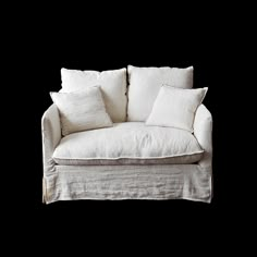 a white couch with four pillows on it's back and one arm folded up